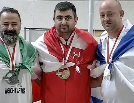 Iranian weightlifter faces lifetime ban for photo with Israeli rival