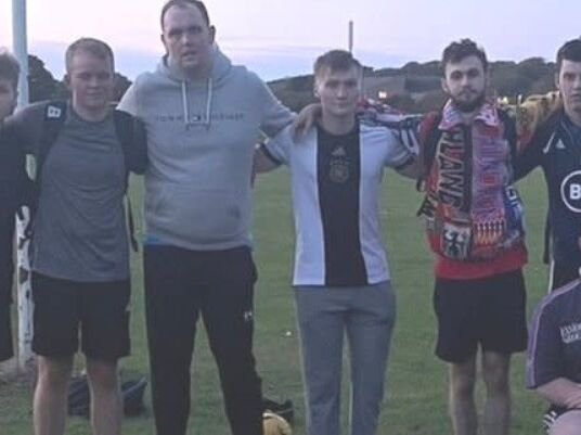 scottish amateur football team smiling after losing 51-0