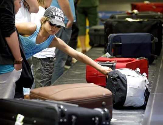 Airline passengers with luggage at the airport