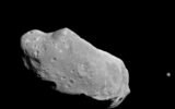 asteroid close to moon in space