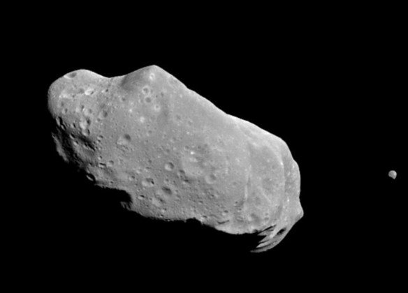 asteroid close to moon in space