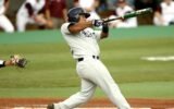 baseball player swinging bat in stadium