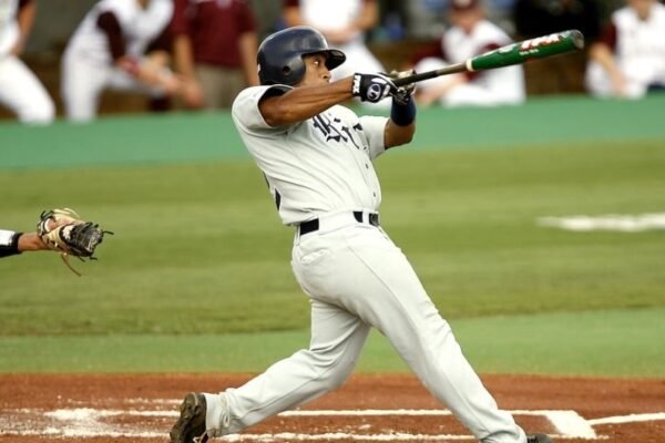 baseball player swinging bat in stadium