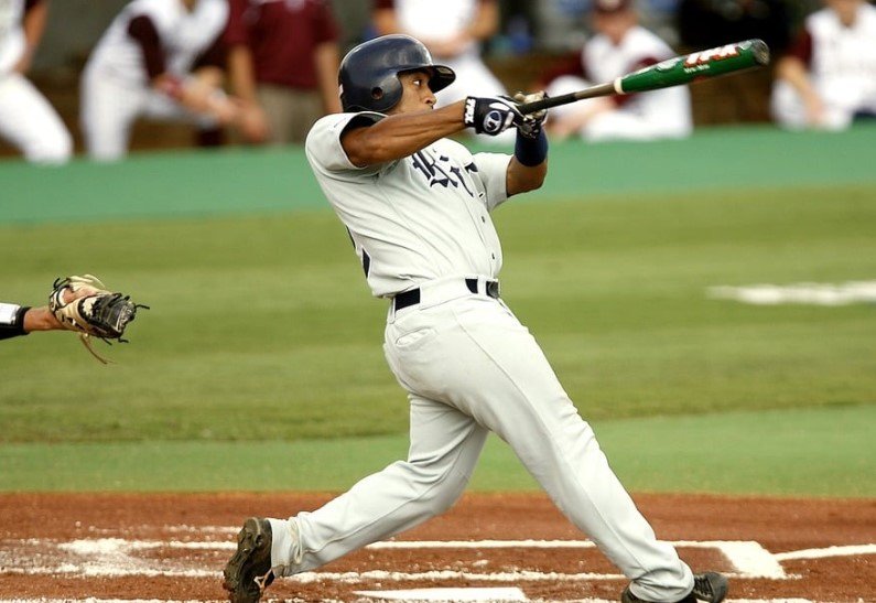 baseball player swinging bat in stadium