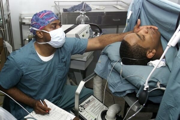 man in hospital bed recovering from surgery