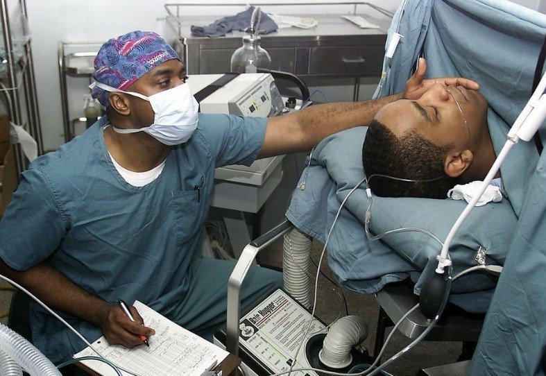 man in hospital bed recovering from surgery