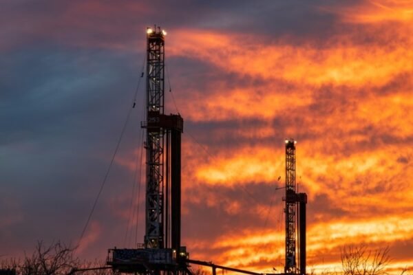 Permian Basin oil rig at sunset with dollar