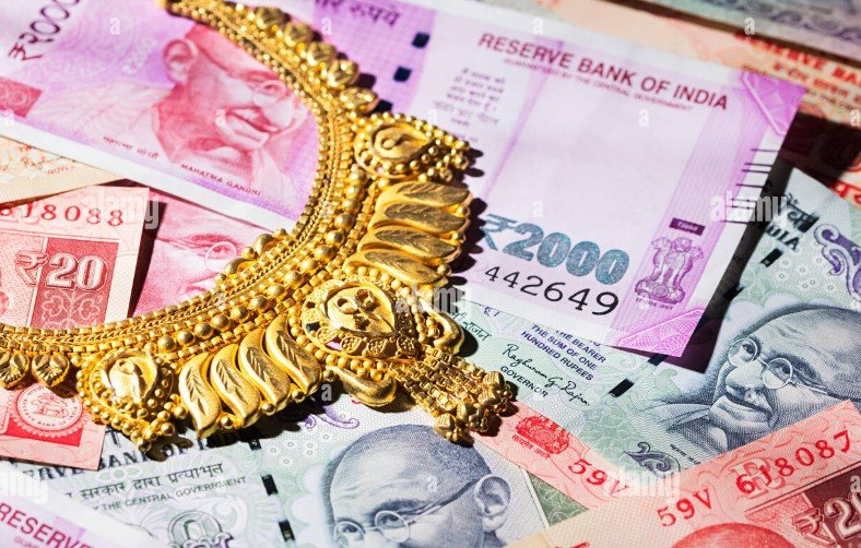 Indian rupee currency notes and gold