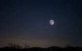 Smallest full moon of 2026 blue micromoon rising low over a dark horizon.