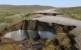 Alaska permafrost thaw sinking road and tundra carbon release